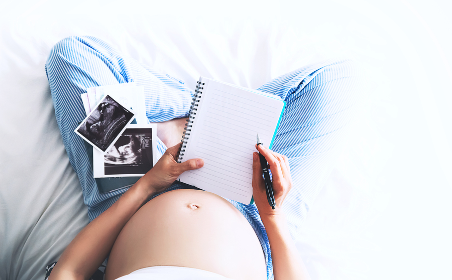 bigstock Pregnant Woman Makes Notes In 183853663
